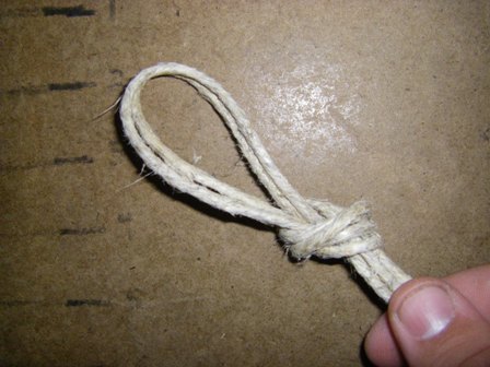 Tie the knot firmly leaving enough of a loop on top to fasten the bracelet when it is finished.