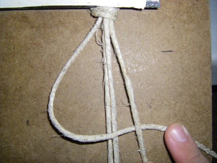 Pass the right tying cord over the top of the left tying cord.