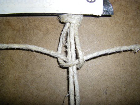 Pull on both of the tying cords to tighten the knot.