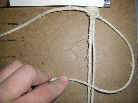 Pass the right tying cord over the top of the two anchor cords.