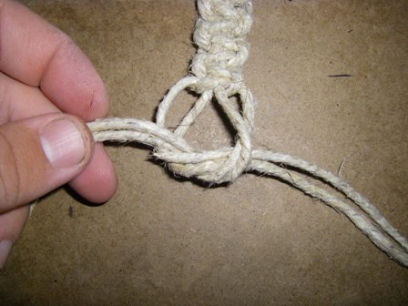 Take the right two cords and pass them through the hole to tie a knot.