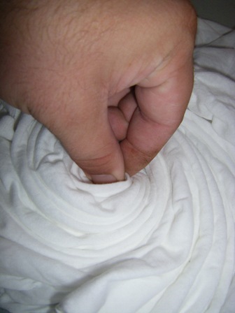 How to tie dye: Grasp the middle of the t-shirt and twist into a spiral.